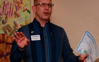 A man holding a business card.