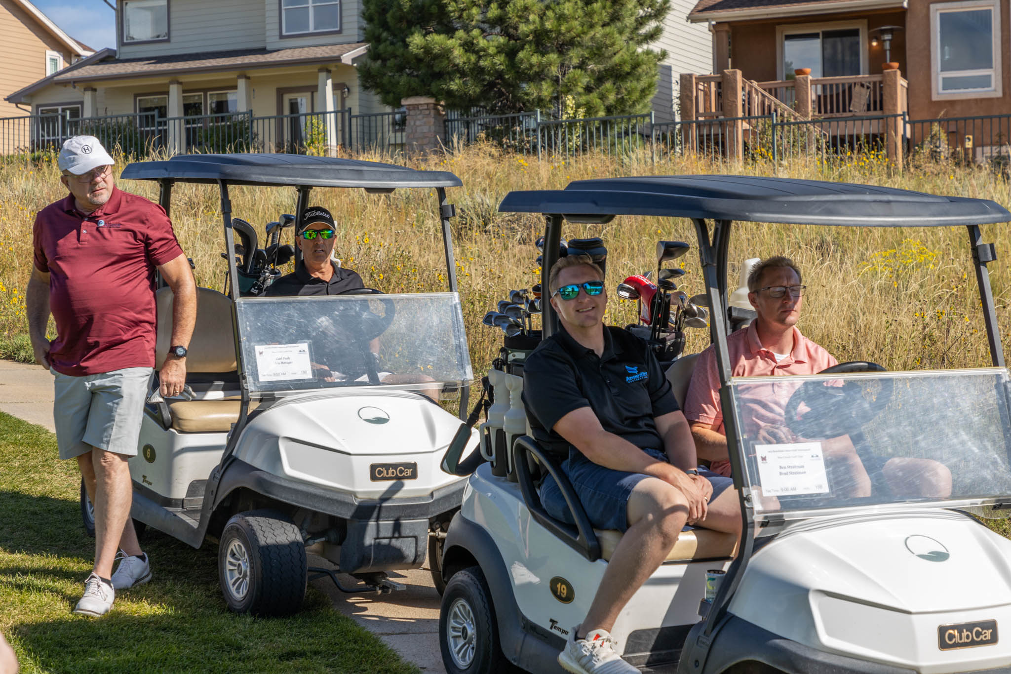 A group of people on golf carts.