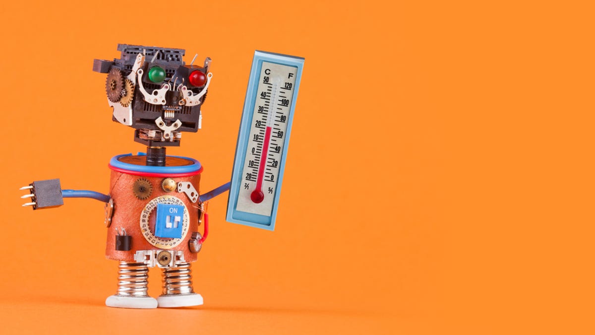 A robot holding a thermometer on an orange background