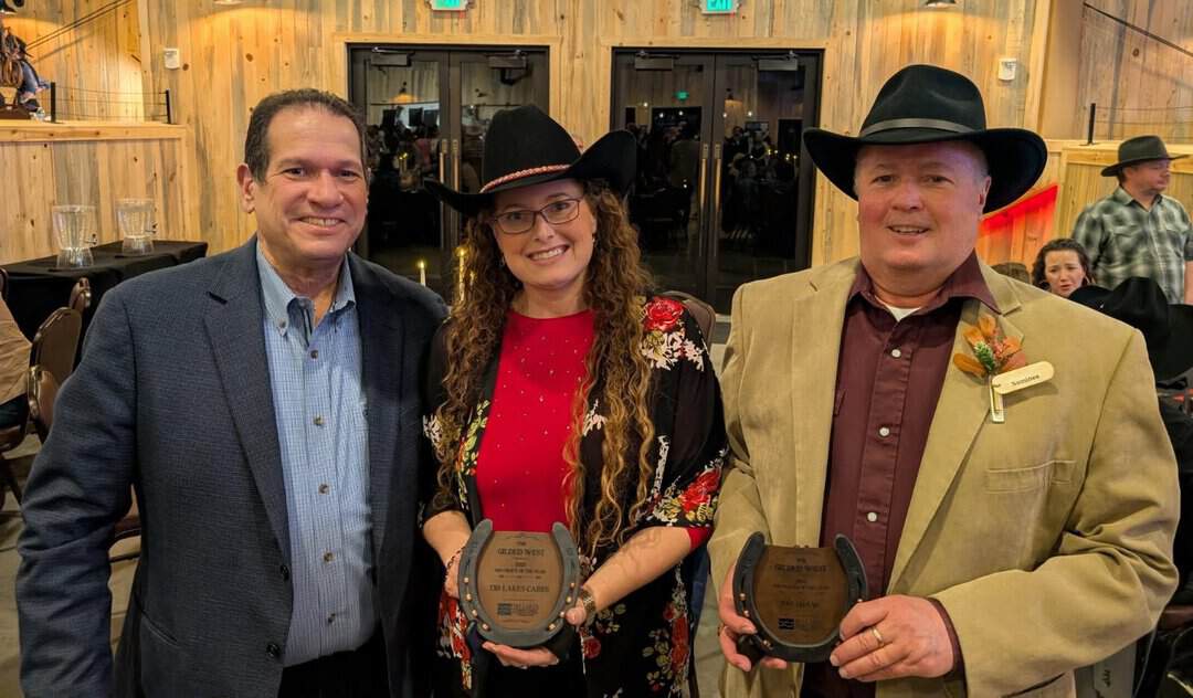 Rich, Haley and Pat – Nora Three people pose indoors at an event, two holding awards shaped like horseshoes. All are dressed in formal or semi-formal attire, with the woman and one man wearing cowboy hats.